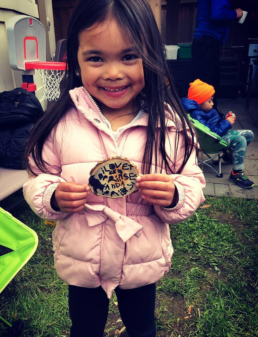 <img src="girl-outside-holding-wish-wood-wish_jpg”  alt="girl standing outside holding the wish she made - wish wood - for making memories and experiences"/>
