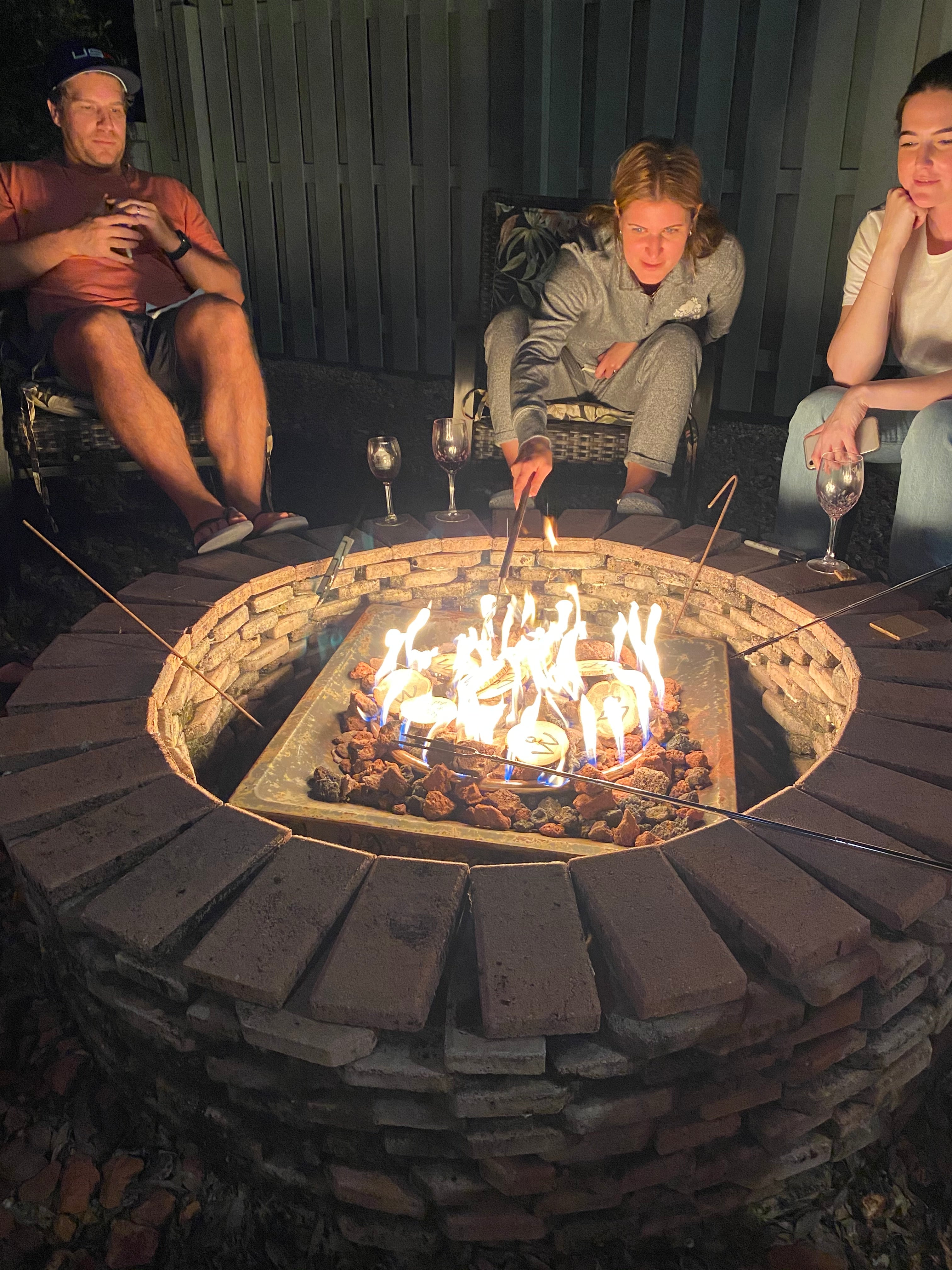 <img src="people-outside-campfire-watching-wishes_jpg”  alt="people outside watching their wishes burn in the campfire - wish wood - for making memories and experiences"/>